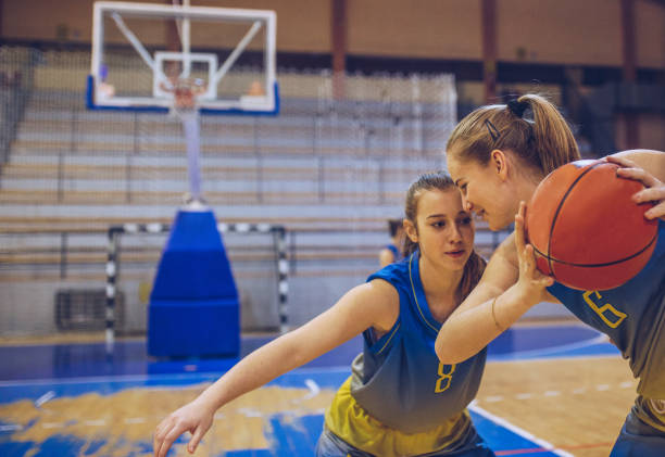 istock Beautiful women playing basketball game 1004266426