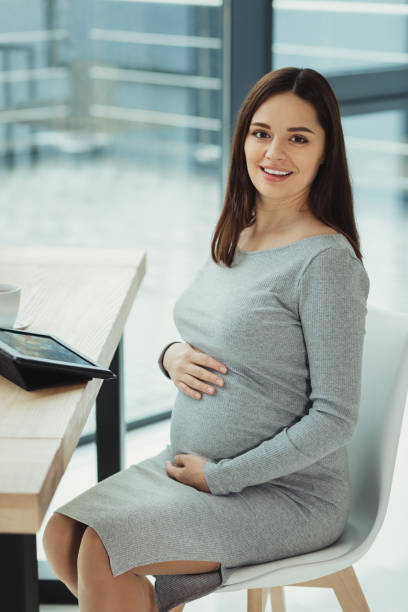 istock Positive manager smiling and expecting a baby 1004266976