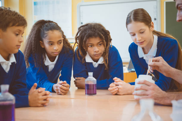 istock Students with chemistry teacher conducting an experiment 1004271760