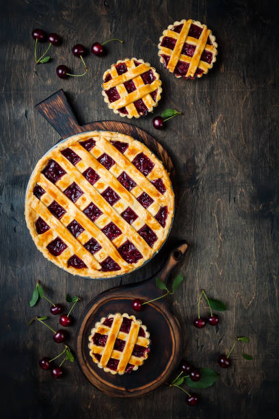 istock Homemade cherry pie on rustic wooden background 1004277088
