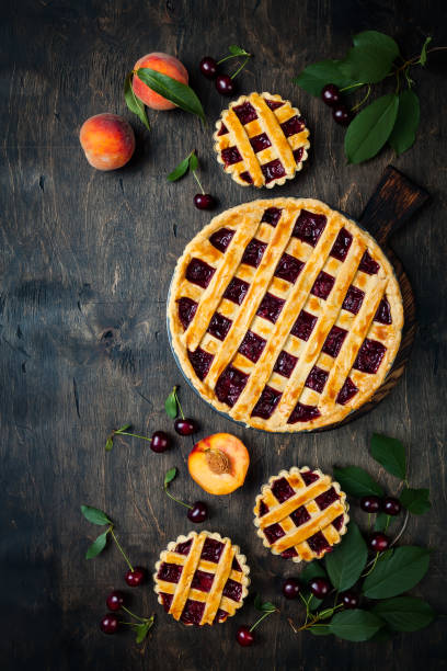istock Homemade cherry pie on rustic wooden background 1004277102