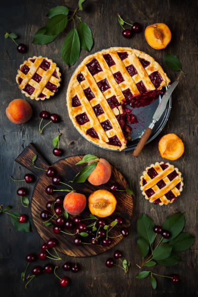 istock Homemade cherry pie on rustic wooden background 1004277104