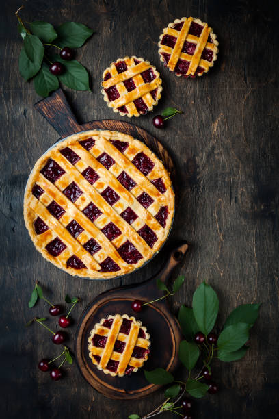 istock Homemade cherry pie on rustic wooden background 1004277112