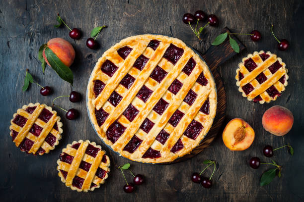 istock Homemade cherry pie on rustic wooden background 1004277172