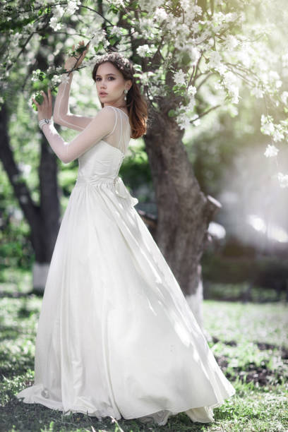 istock Beautiful young bride in a blooming garden 1004277484