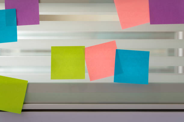 istock Randomly scattered colored sticky notes over glass screen of a bench desk 1004277524