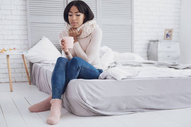 istock Young woman drinking hot tea 1004281704