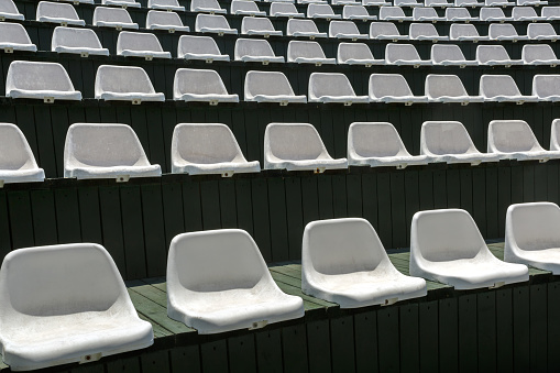 Rows of empty white chairs in the open summer hall for entertainment