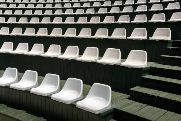 istock Rows of white plastic armchairs in an open summer concert hall 1004284186