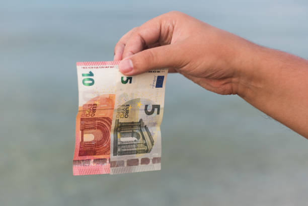 istock Hand holding fifteen euros 1004284594