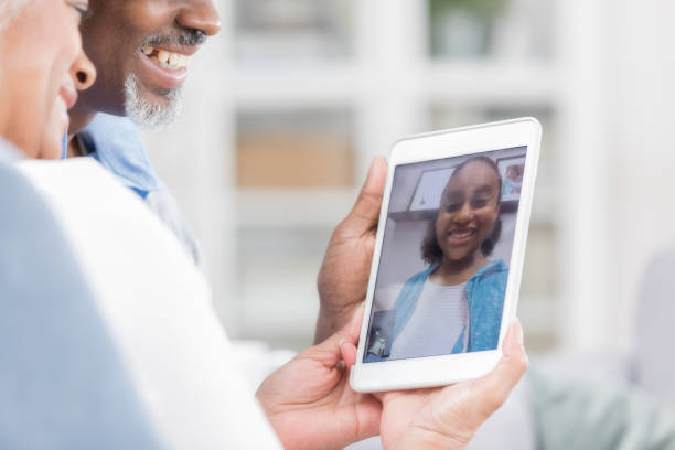 istock Unrecognizable senior couple video chat with granddaughter 1004303788