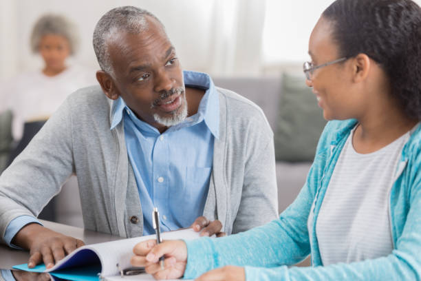 istock Senior man helps granddaughter with homework 1004303810