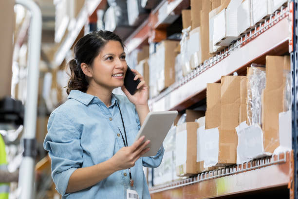 istock Cheerful female distribution warehouse manager checking inventory 1004303910
