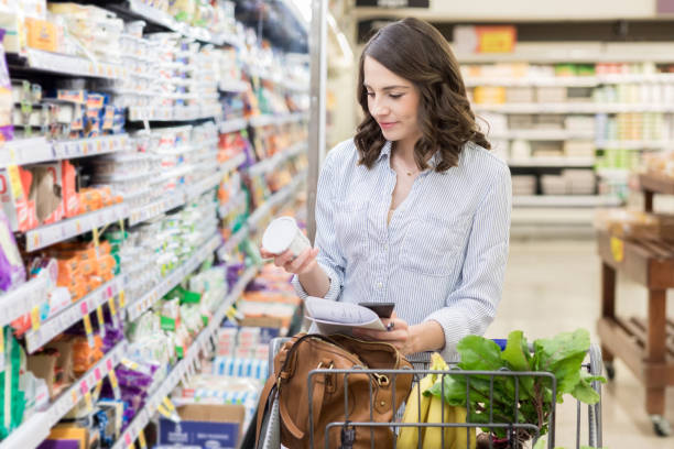 istock Young woman grocery shops for dairy items 1004304036