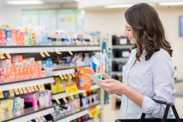 istock Young woman searches for medication in pharmacy 1004304048