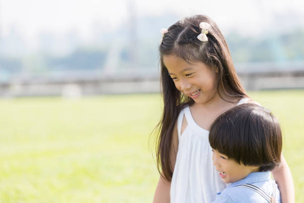 istock Adorable brother and sister embracing outside 1004304178