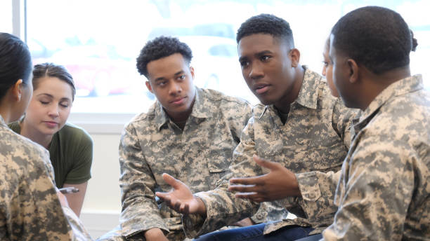 istock Group of military recruits in serious discussion 1004304338