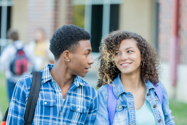 istock High school couple walking to class 1004308968