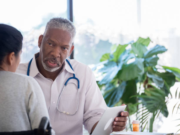 istock Senior doctor discusses medication with female patient 1004309078