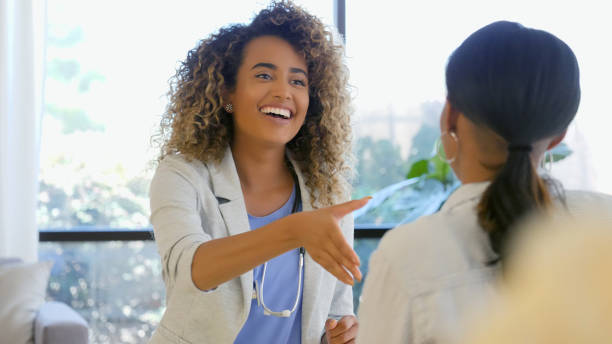 istock Friendly doctor greet new patient 1004309126