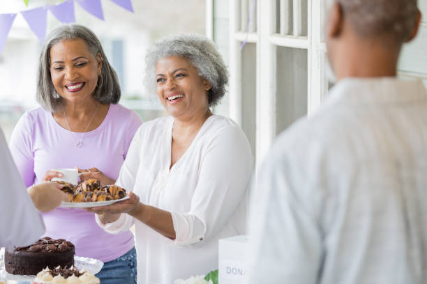 istock Women serve coffee and dessert during charity fundraiser 1004309174