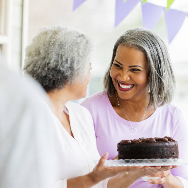 istock Women serve cake at birthday party 1004309176