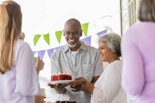 istock Cheerful couple donate cake to bake sale 1004309182
