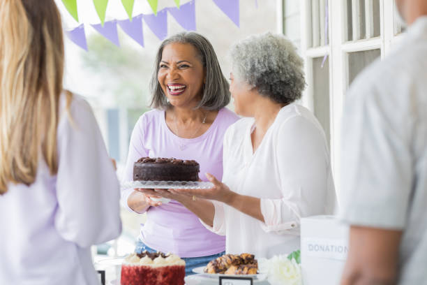 istock Women sell cake during bake sale 1004309184