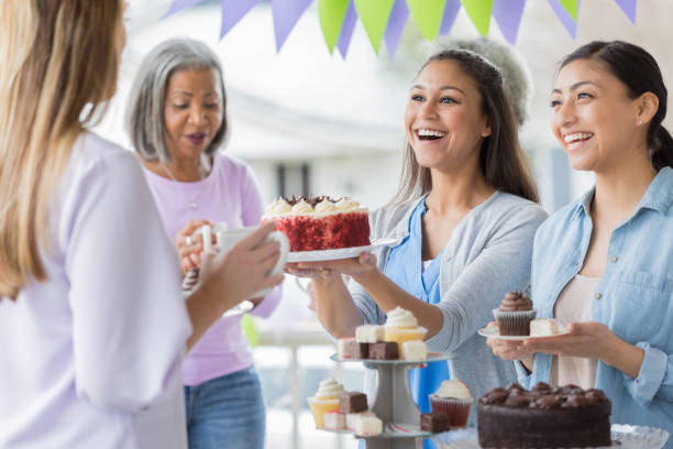 istock Customer buys cake at bake sale 1004309222