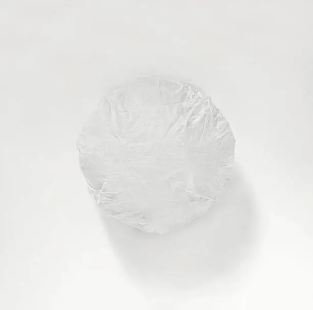 Photo of Classic burger packed in the wrapping paper on white background. Top view.