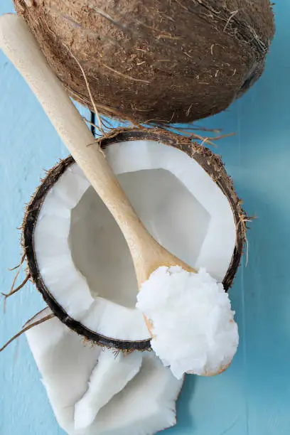 image of coconuts with coconut oil on wooden table