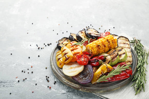 istock Grilled vegetable on brown cutting board with rosemary 1004337752