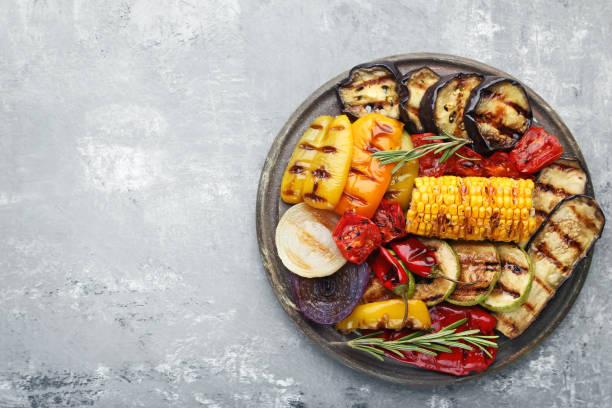 istock Grilled vegetable on brown cutting board with rosemary 1004338260