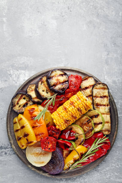 istock Grilled vegetable on brown cutting board with rosemary 1004340846