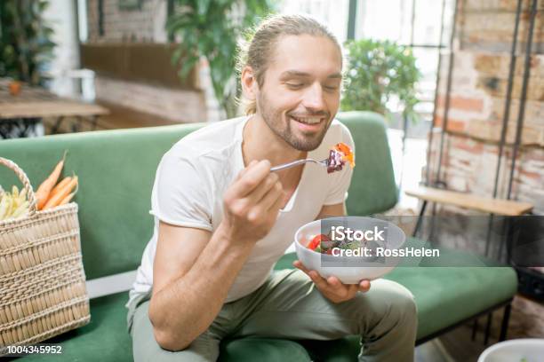 Vegetarian Man Eating Salad Indoors Stock Photo - Download Image Now - Eating, Men, Healthy Eating