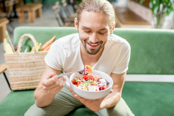 istock Vegetarian man eating salad indoors 1004346032
