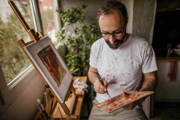 Mature artist on his art studio