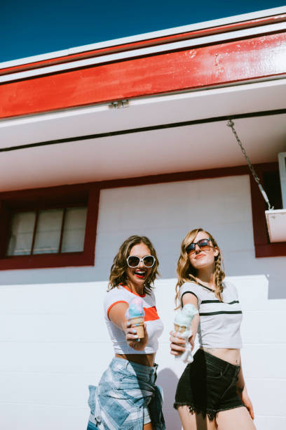 istock Summer Friends Enjoy Ice Cream Cones on Hot Day 1004363782