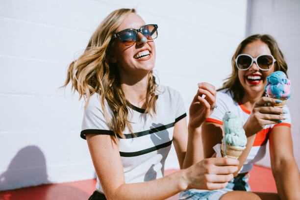 istock Summer Friends Enjoy Ice Cream Cones on Hot Day 1004369256