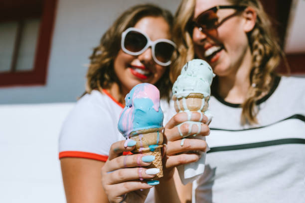 istock Summer Friends Enjoy Ice Cream Cones on Hot Day 1004369586