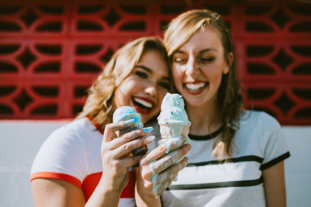 istock Summer Friends Enjoy Ice Cream Cones on Hot Day 1004369784