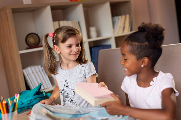 istock Girls packing school bags 1004391548