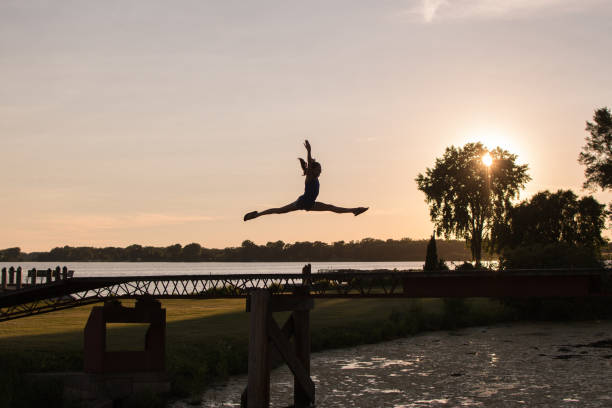 istock Girl by lake looking out into water 1004399380