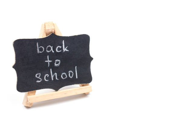 istock Small blackboard with Back to School words isolated on white 1004403580