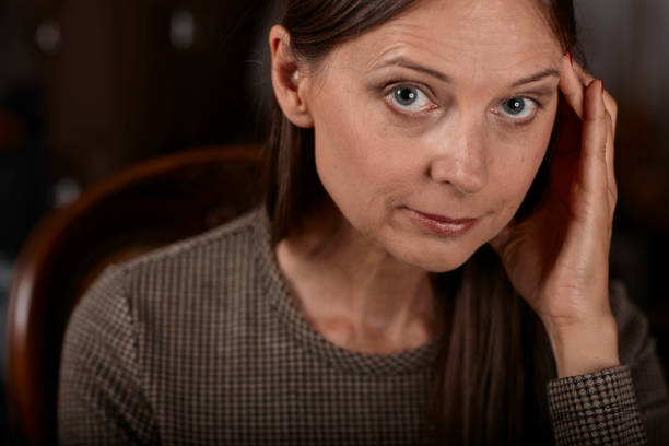 istock women on a chair feeling sick itself because of a headache 1004427532
