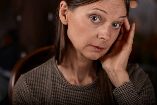 istock women on a chair feeling sick itself because of a headache 1004427562