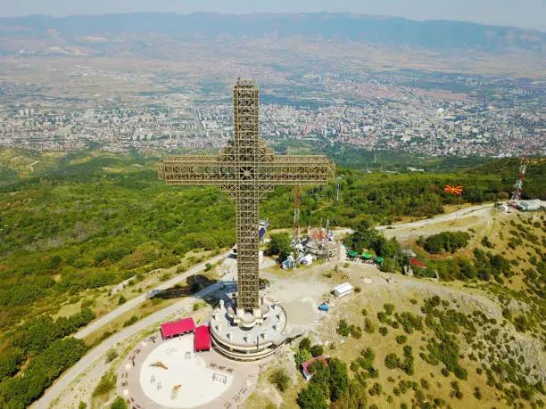 Photo of Aerial view of Great cross of steel structure against cityscape, Macedonia.