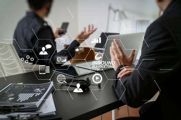 istock co working meeting,two businessman using VOIP headset with latop computer on desk in modern office as call center and customer service help desk concept with virtual interface graphic icons network diagram 1004439520