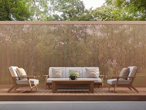 Outdoor living area with wood slats 3d render,Surrounded by the nature.There are wooden floor and wall slats partition.There have the sunlight into the floor.
