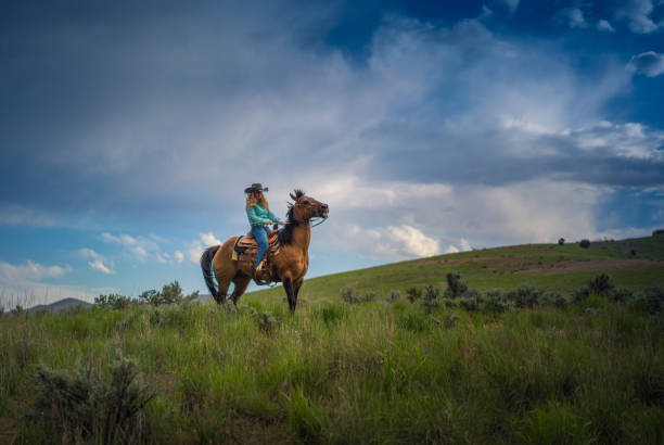 istock Cowgirl Horseback Riding 1004459944